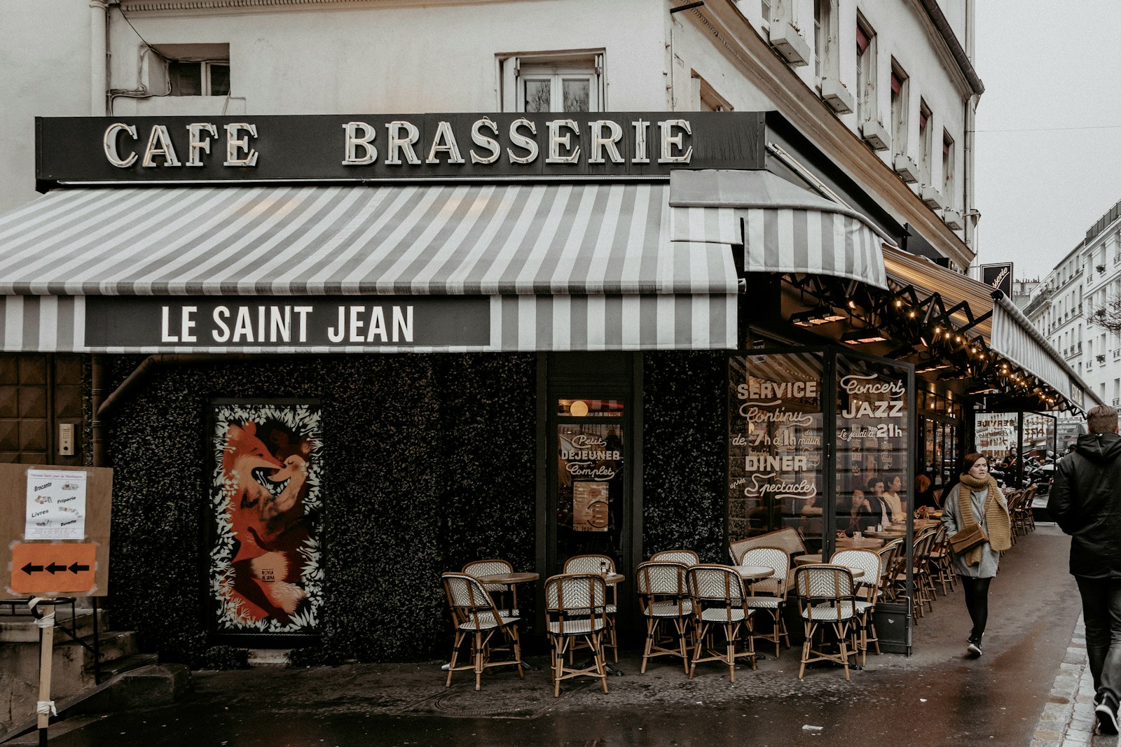 A classic Parisian café terrace with woven bistro chairs on a cobbled street