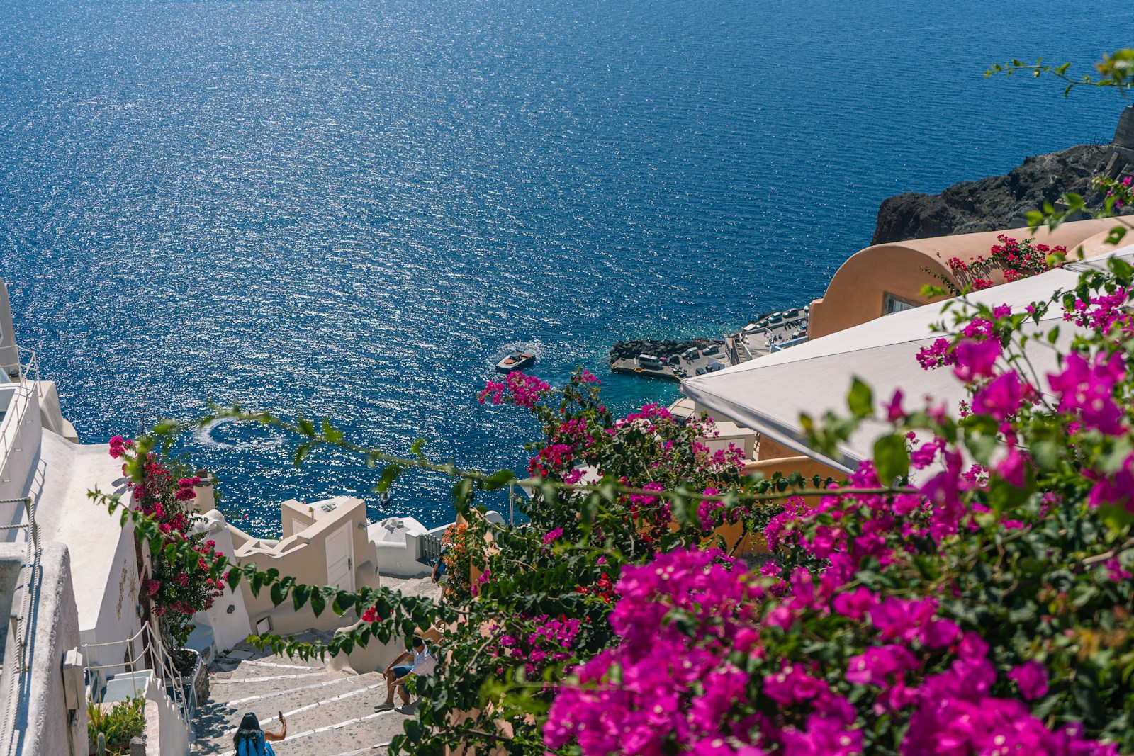 A quiet whitewashed lane winding between houses in Santorini
