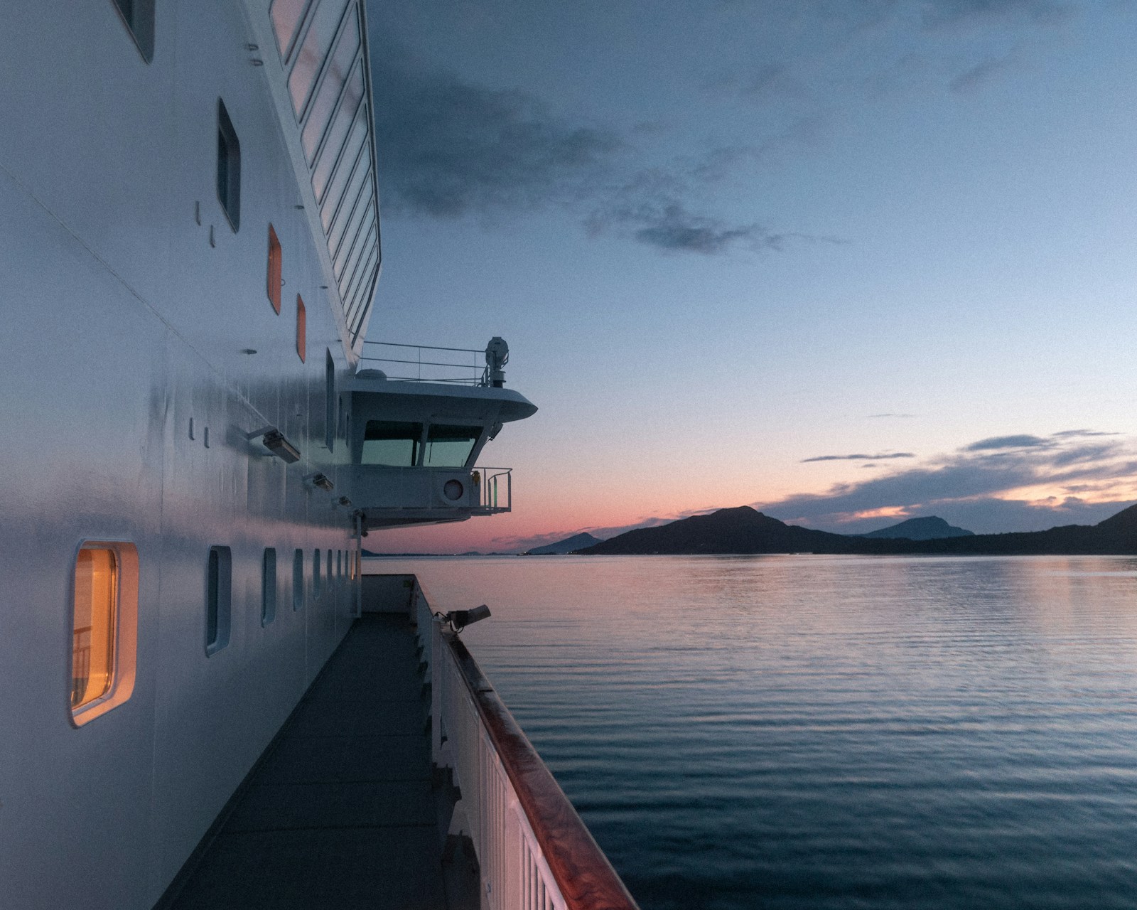 A cruise ship at sea beneath a wide open sky
